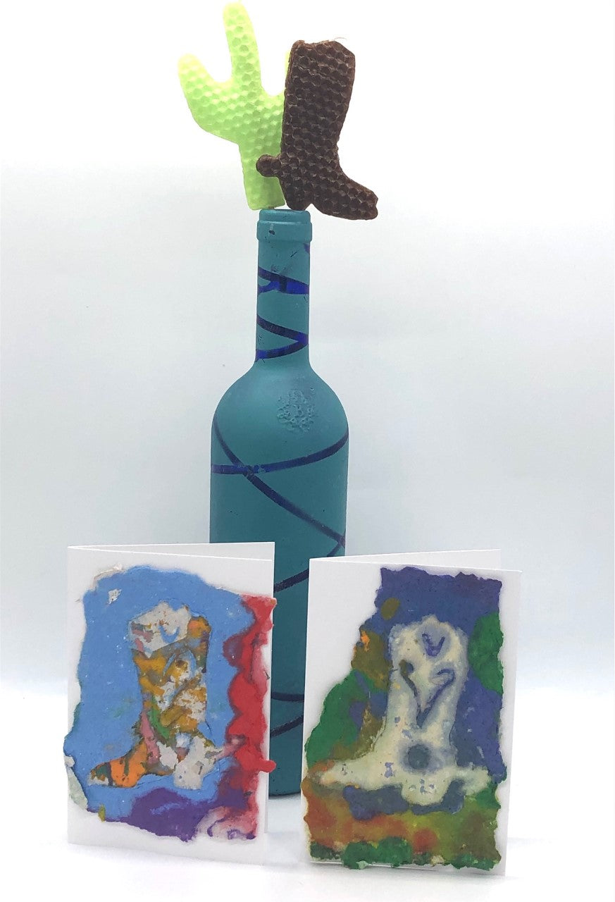 wine bottle with cactus and boot candle coming out the top, cards with pictures of cowboy boots made from handmade paper