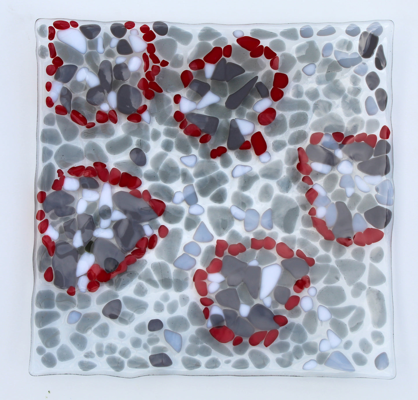 glass platter with grays , white and highlights of red