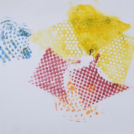 Ink on paper artwork with yellow, blue, red and orange sponge paint