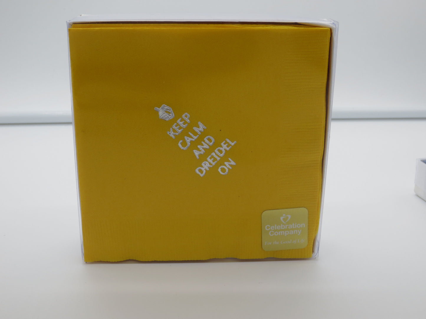 Packaged yellow cocktail napkins with silver dreidel and Keep Calm and Dreidel On slogan
