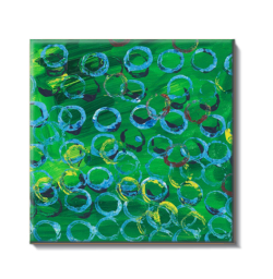 ceramic coaster with lue dots ontop of a green background
