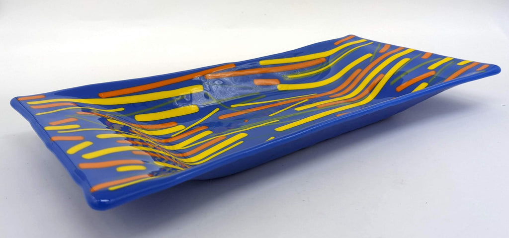 blue glass tray with horizontal lines of orange and yellow