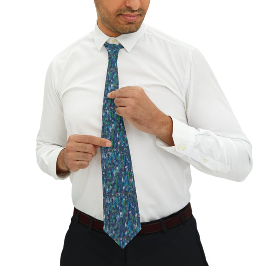 Man wearing a neck tie that is a mixture of blues and greens.