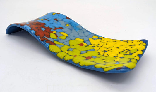 S-curved spoon rest covered in blues, yellows, and red
