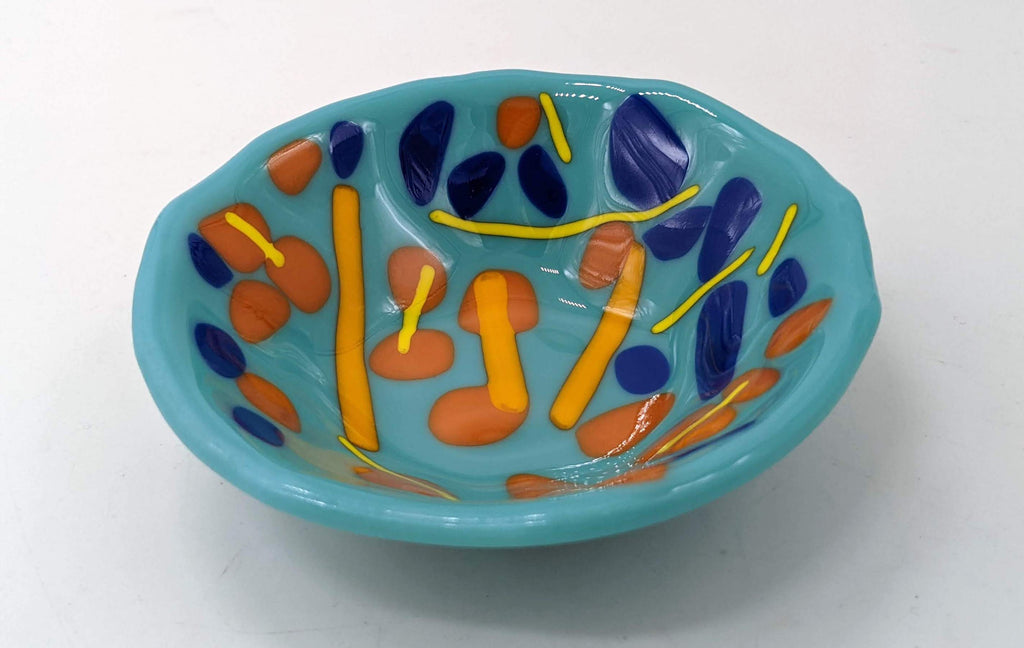 blue trinket bowl with orange dots and lines