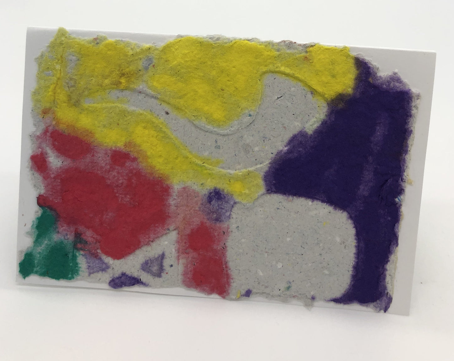 Yellow, purple, red and green background with a shofar in natural paper color on top.  There are two indistinguishable random  shapes on top also.