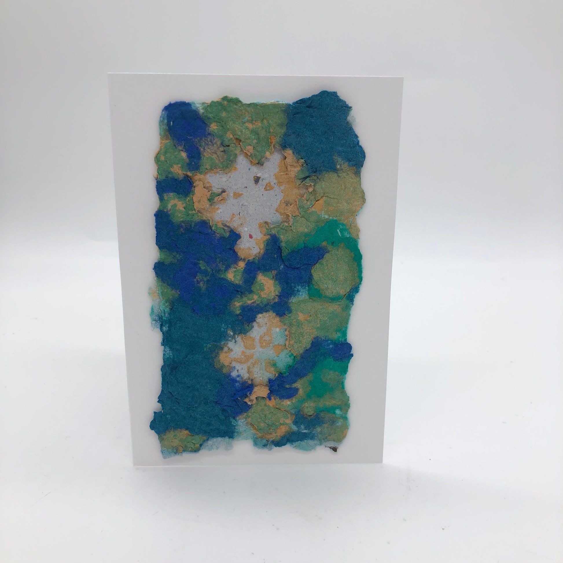 Handmade paper greeting card with cream, aqua and blue background with two white snowflakes