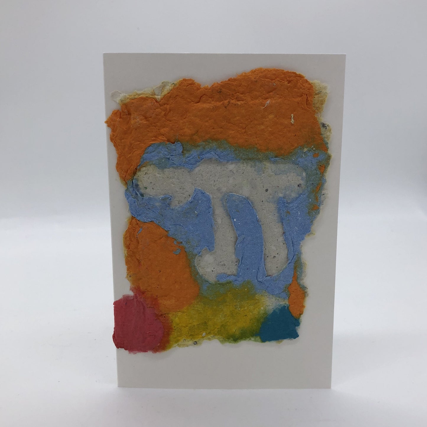 Handmade paper greeting card with white Chai against golden yellow, light blue, a little red and bright yellow background