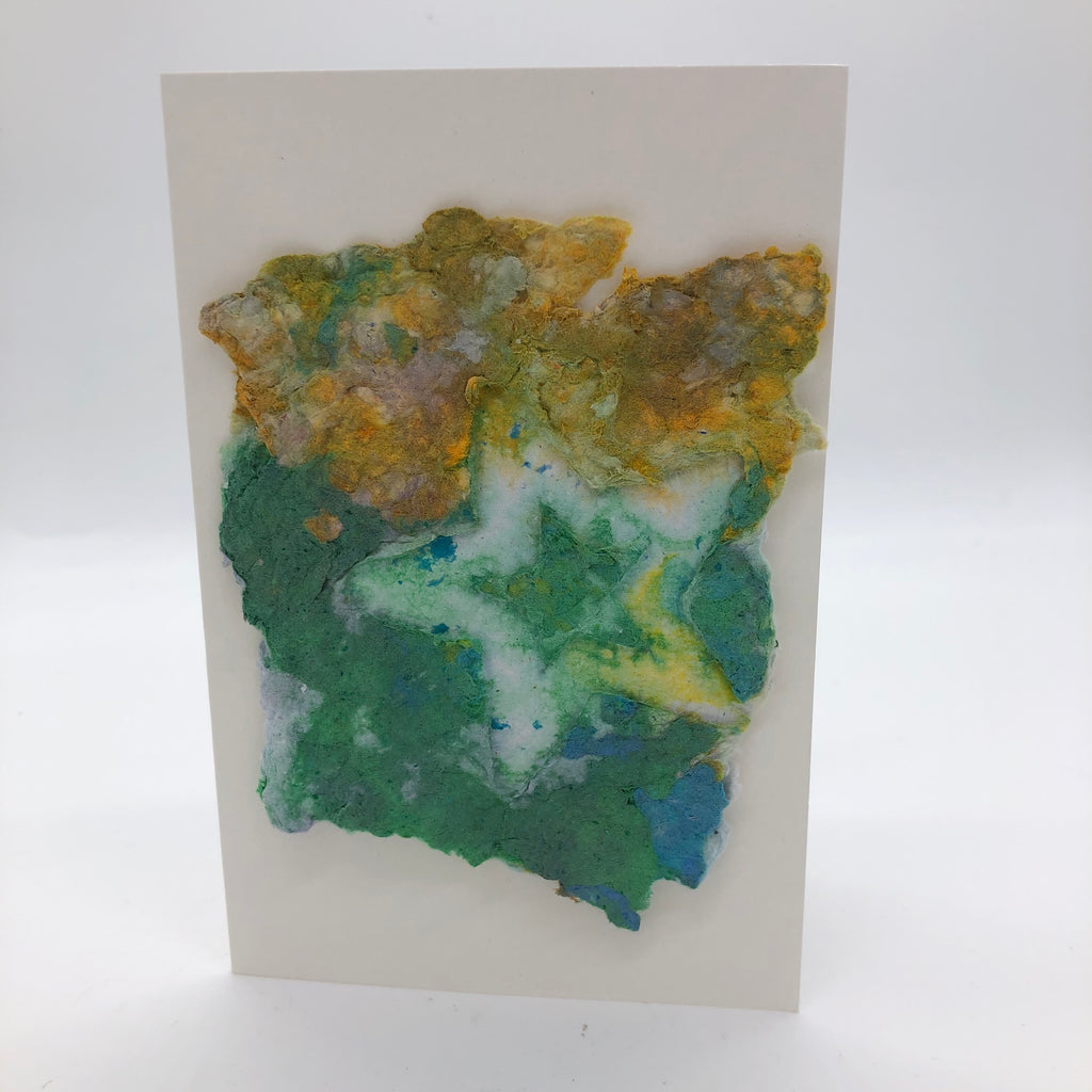 Handmade paper card with background in green and yellow-mixed with some green.  The star is in white with a smaller green star inside the bigger star.