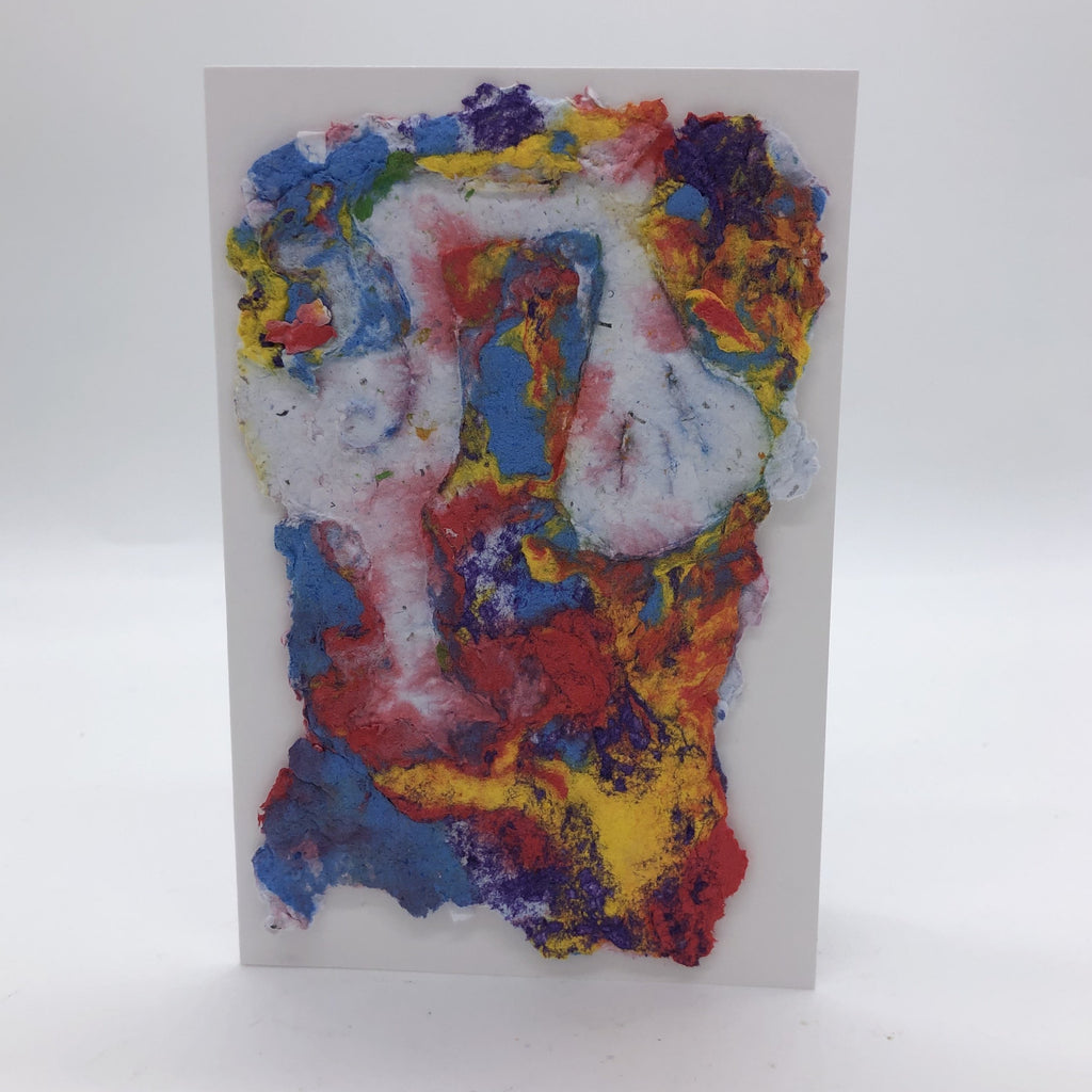 Handmade paper greeting card with background in a combination of blue, purple, yellow and red, in almost a marbled design and a white Stork holding a bag