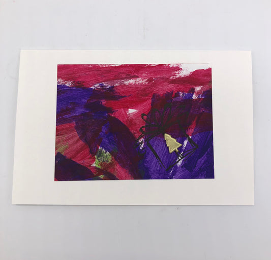 White greeting card with acrylic painting in purple and maroon.  There is a stamp of a gift box with bow outlined in black with a small gold metal christmas tree glued on where the gift is shown.