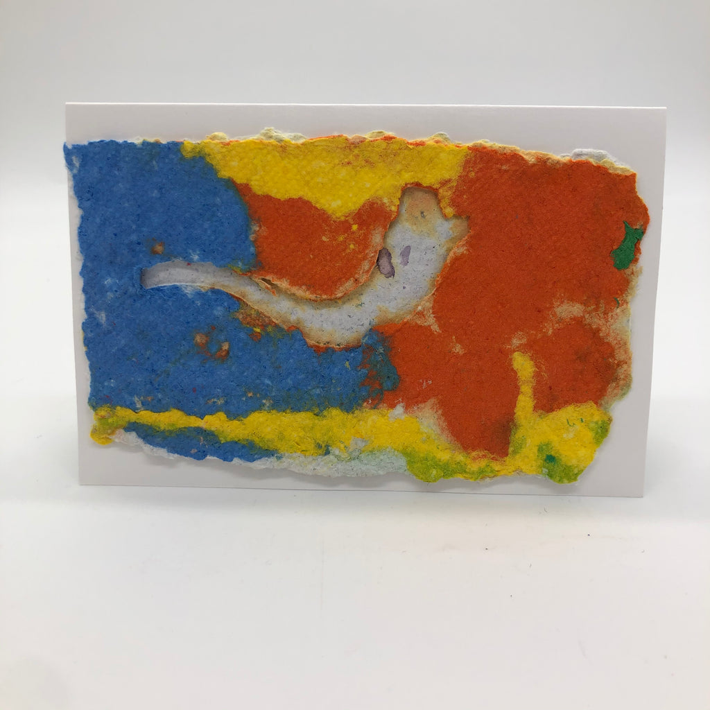 Handmade paper card with bakground in blue, yellow and orange.  One white shofar is on top.