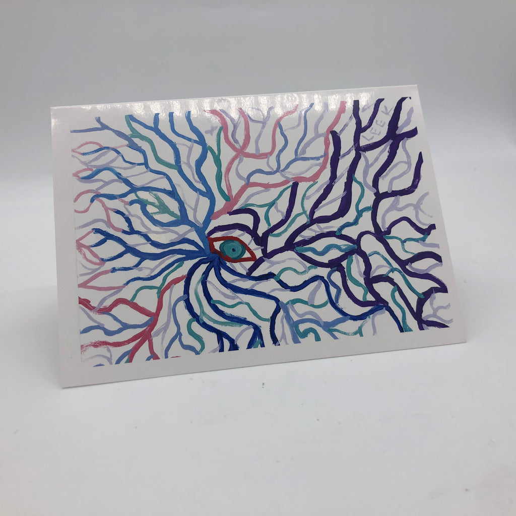 Printed graphic card with a small blue-green eye in the middle.  THe eye is outlined in red and radiating from eye are branch like lines in blues, red, pink, greens and purple.