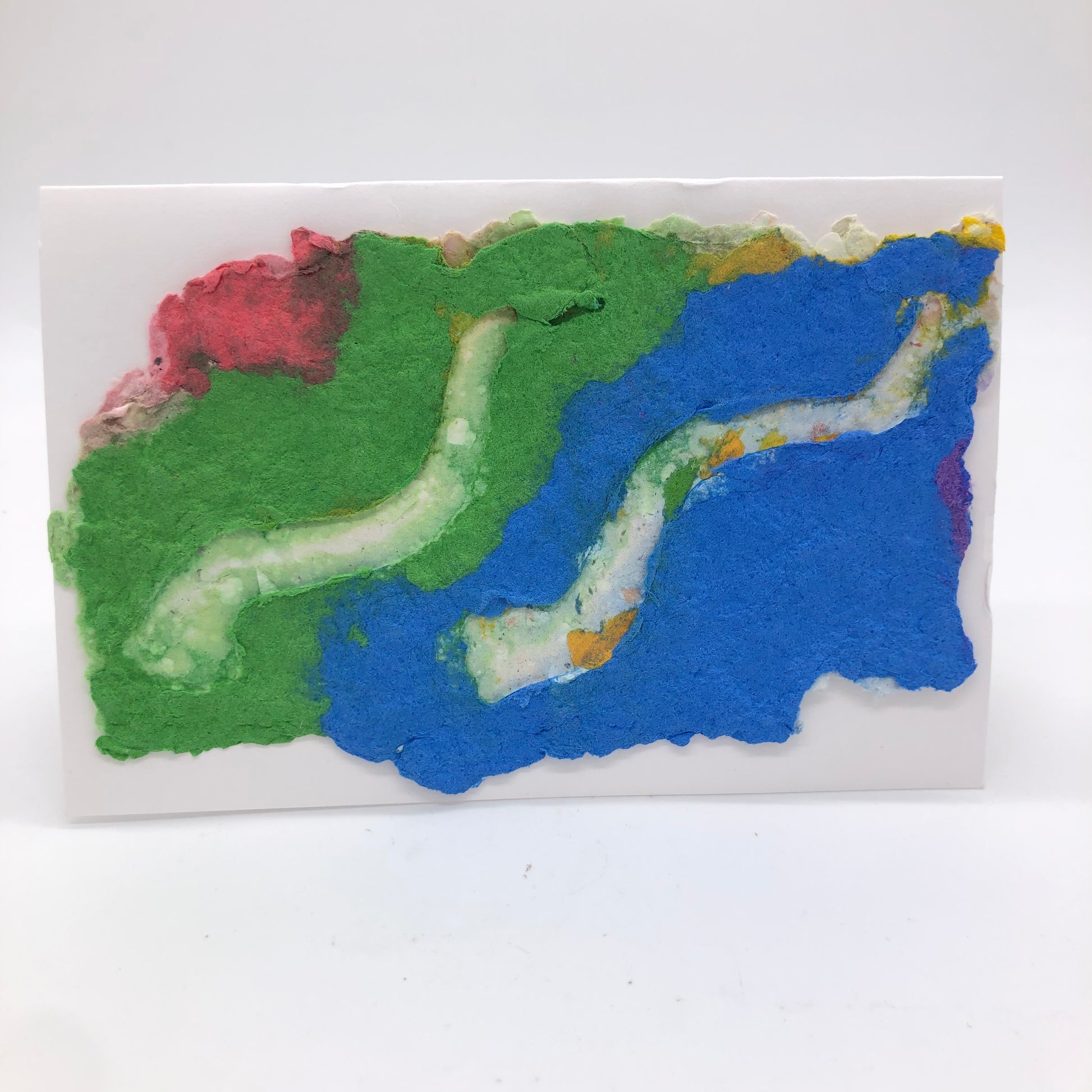 Handmade paper card with background in green and blue with a little pink..  Two white shofar are on top.