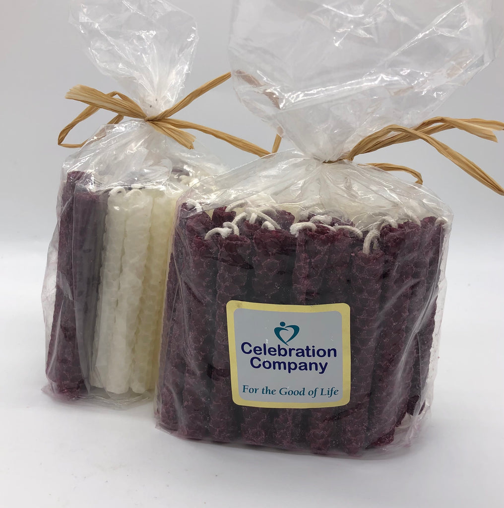 Two Packages of 44 Chanukah candles in Aggie maroon and white.  The package is tied with raffia on top and has a white logo sticker on the front.