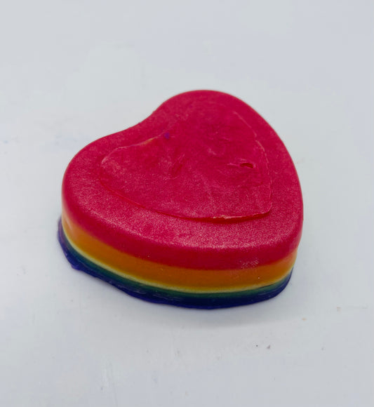 Heart shape soap layered in )from top) red, orange, yellow, green and blue.