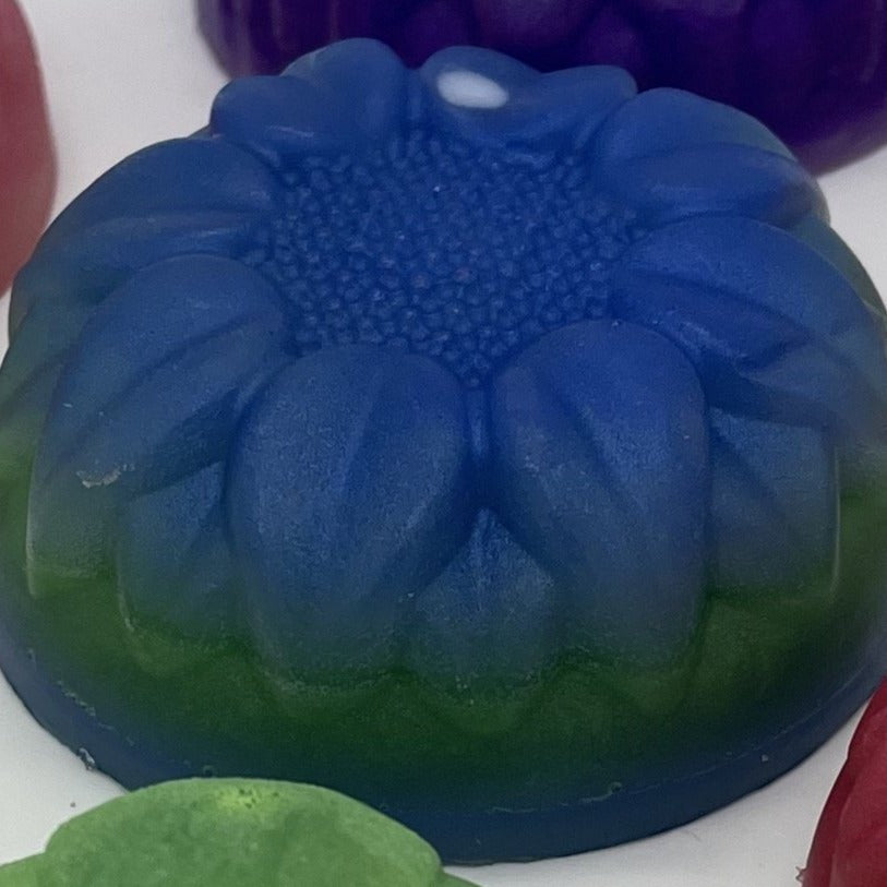 Round floral soap in blue and green layers.