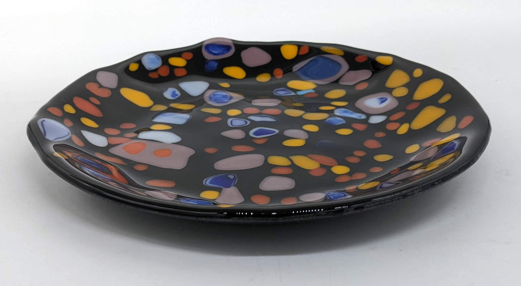 Black glass plate with yellow, orange, light purple and blue specks