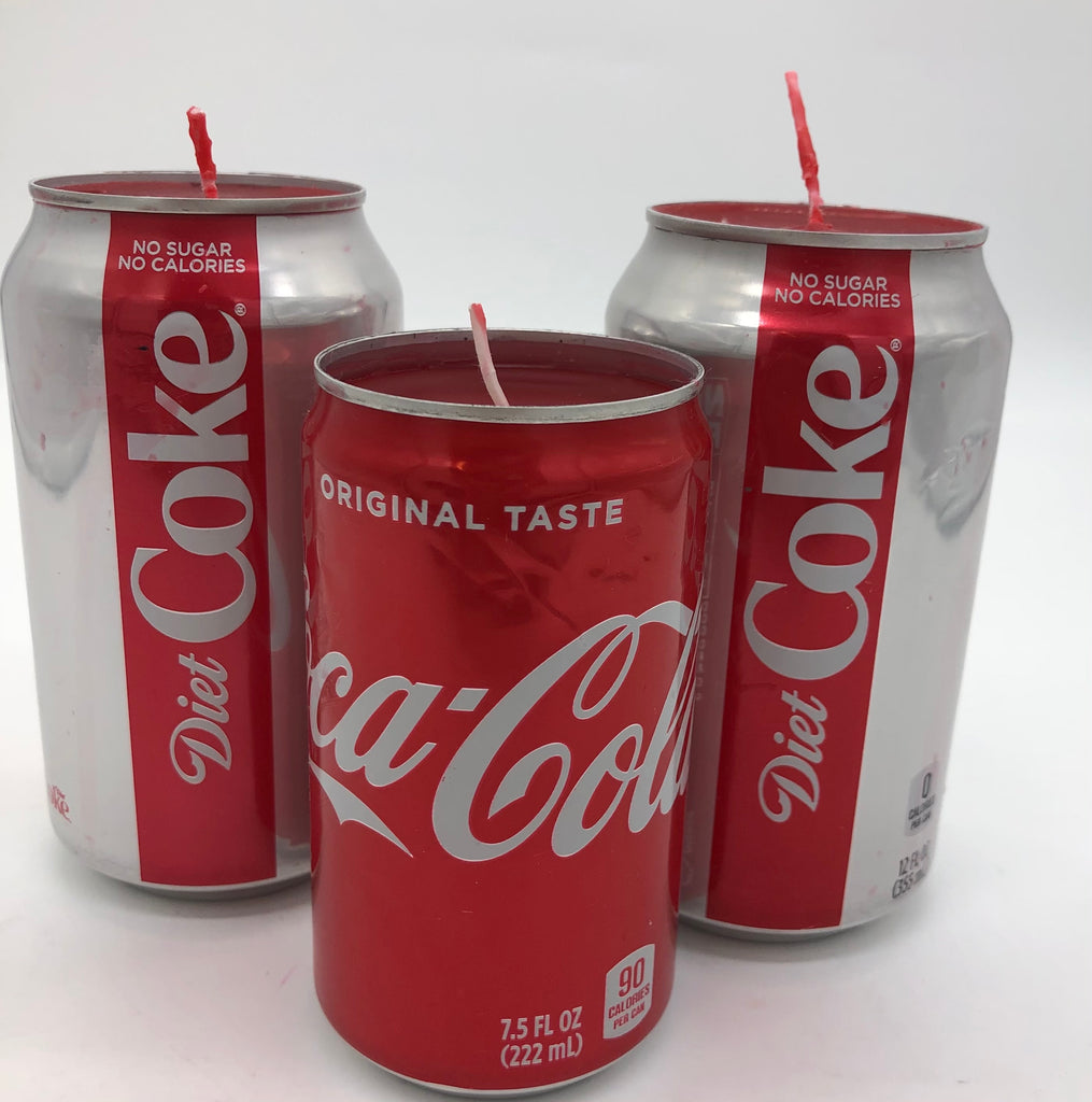 Three aluminum cans recycled into vessels for candles.