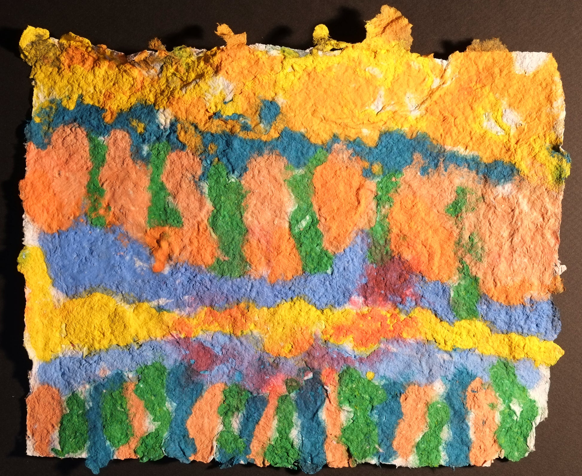 Highly textured handmade paper with horizontal lines of turquoise, light blue and yellow. There are green and turquoise vertical lines in between the horizontal lines amongst an orange and yellow background