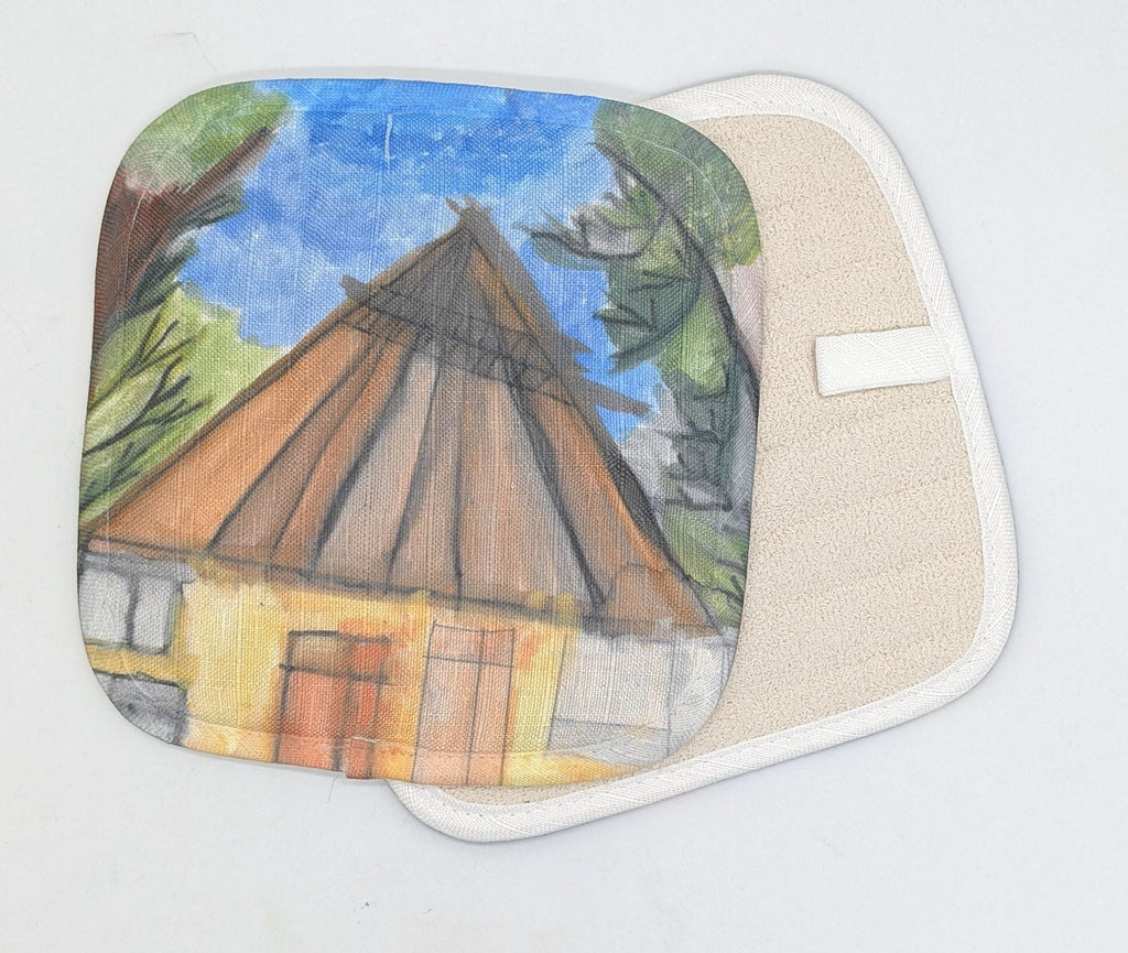 This is a potholder with the following paintings: This is a house with a roof and two trees on either side of rhe house. There is a blue sky.