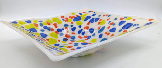 white square glass bowl with spots of blue, orange, and light green throughout 