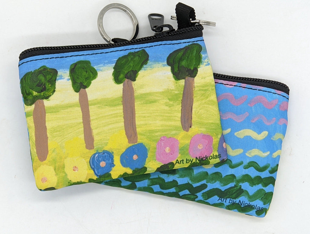 This is a coinpurse with the following painting: This is a painting with a blue background and green, yellow and pink horizontal squiggles.