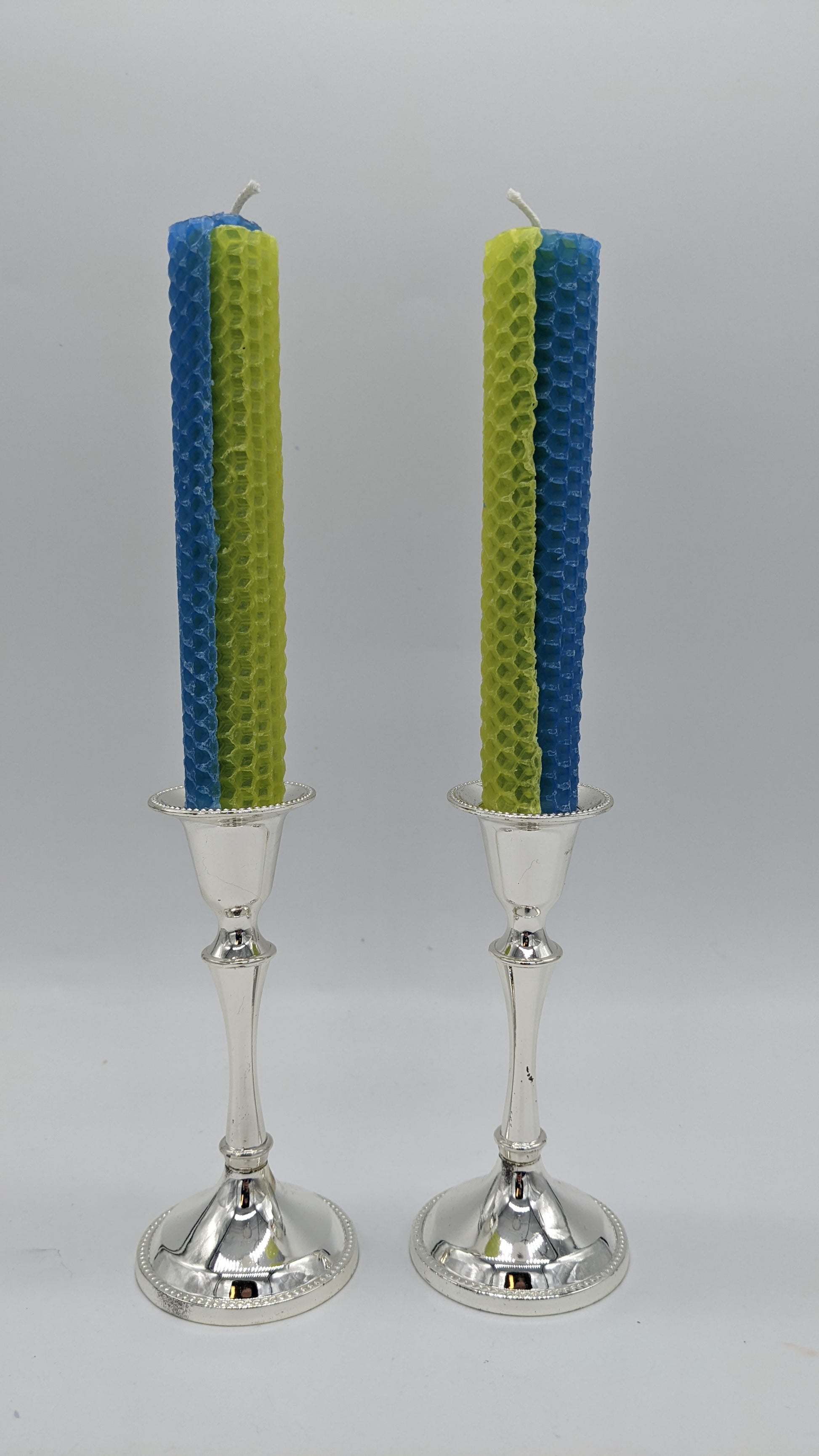 pair of yellow and blue striped shabbat candles