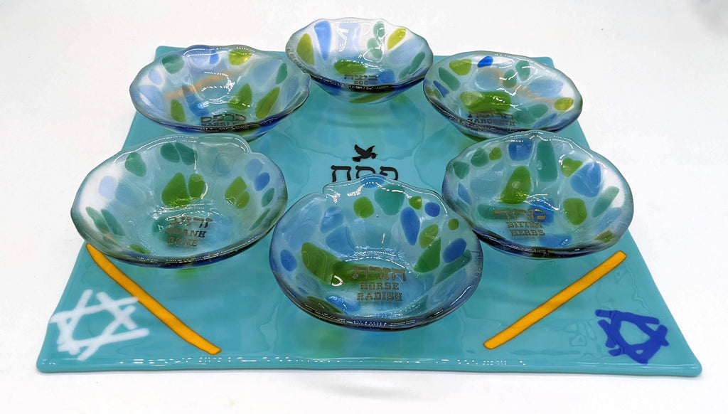 blue seder plate , with clear glass cups for each item