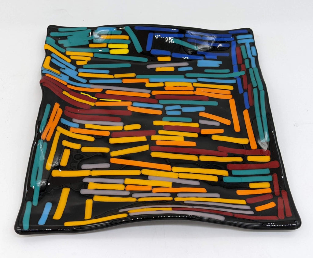 black wavy plate completely covered in colorful lines