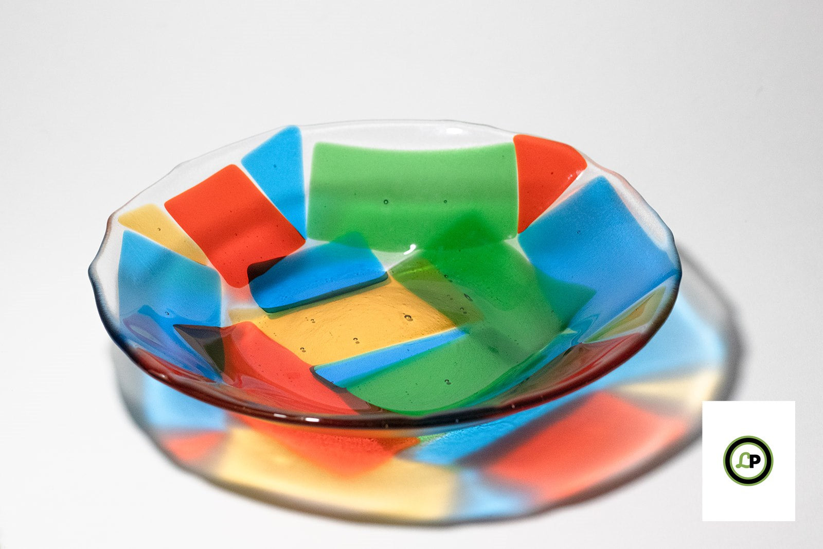 yellow, green, blue, and red glass on a bowl
