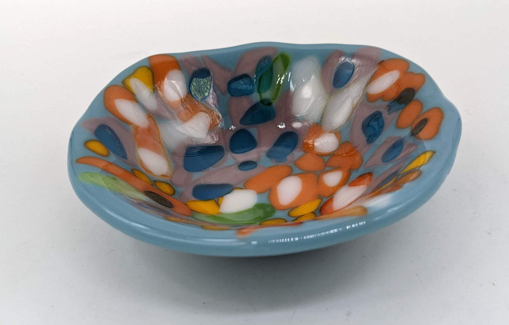 blue bowl completely covered in purple, orange, yellow and green dots