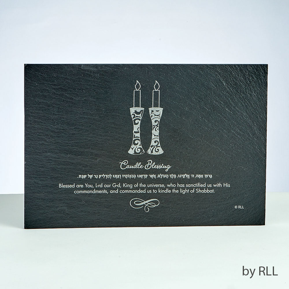black slate rectangle with image of candle sticks and blessings etched in