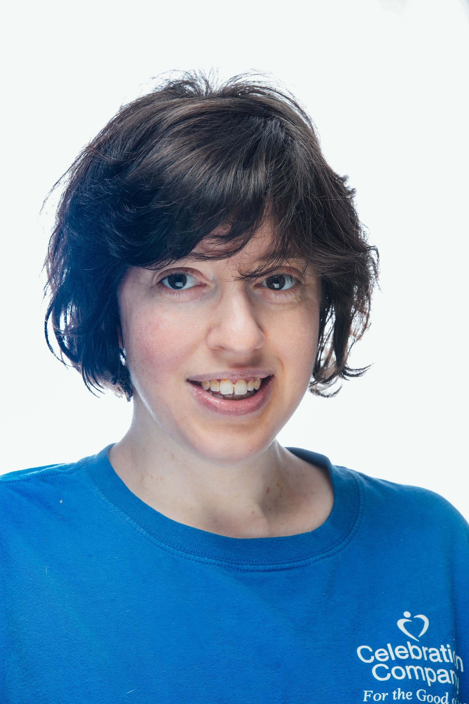 Image of artist smiling, wearing a blue shirt