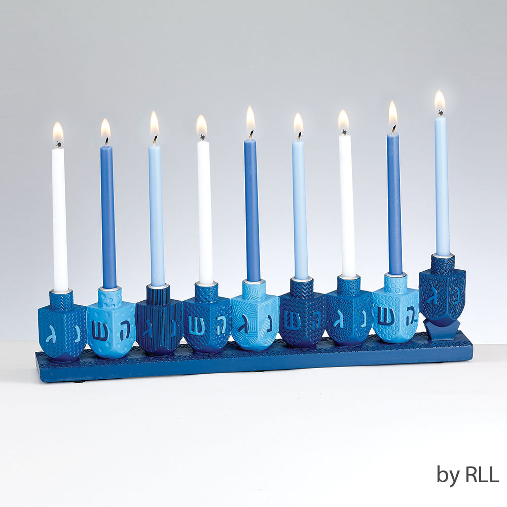 menorah with various shades of blue dreidels as the base holding blue and white lit Chanukah candles