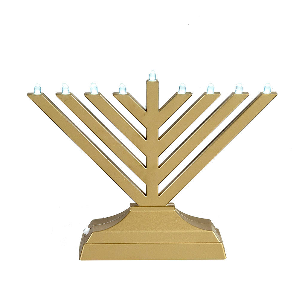 gold electric menorah in front of white background