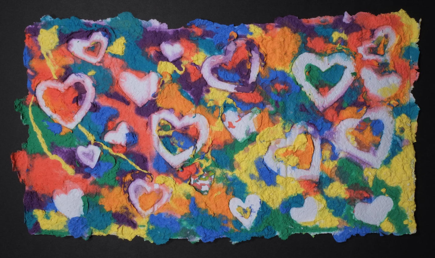 Highly textured handmade paper with various bright colors and embossed white hearts