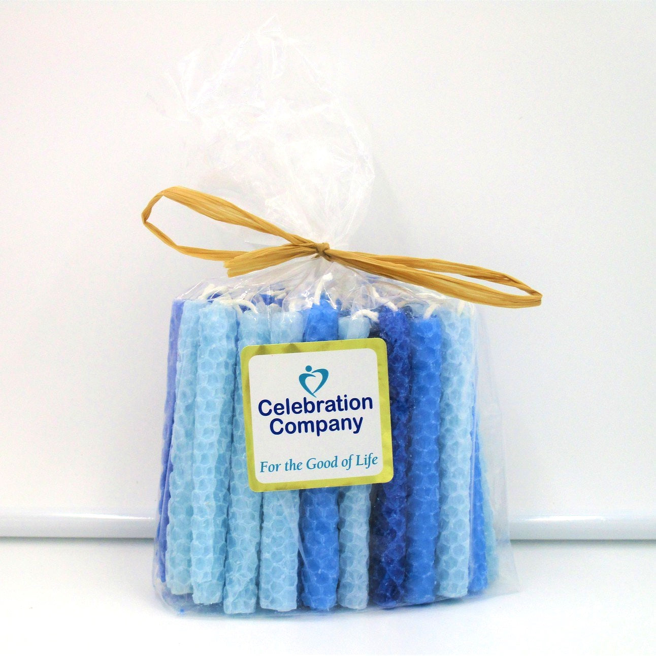 Packaged hand rolled beeswax Chanukah candles with various blue colors
