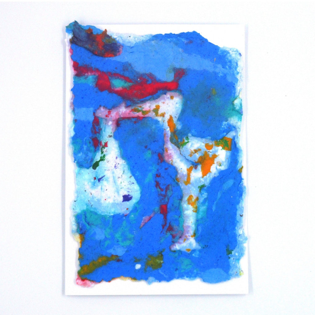 Handmade paper greeting card with a mostly blue background with red and orange accents and a white Stork holding a bag