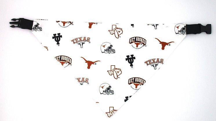 Photo of triangular dog bandana with black plastic closure.  Background of fabric is white with several types of UT graphics including the Longhorn in burnt orange, the UT logo in black, the shape of Texas, a helmet, GET HOOKED and TEXAS..
