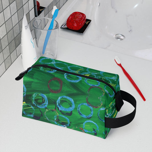 toiletry bag with lue dots ontop of a green background