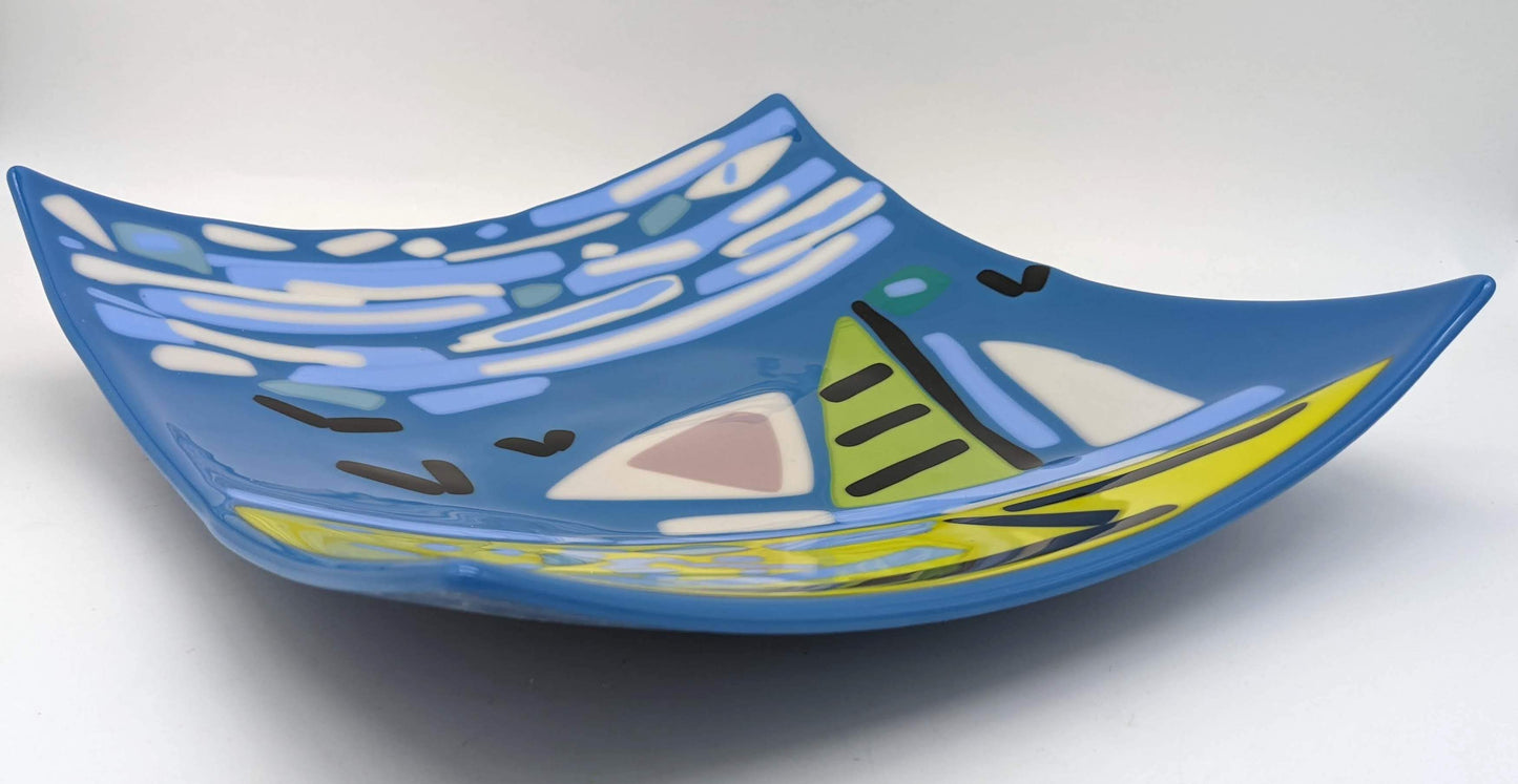 blue glass tray with a depiction of a sailboat, birds, and a sky