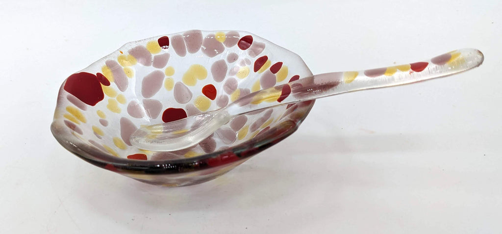 glass bowl and spoon set with reds and yellow