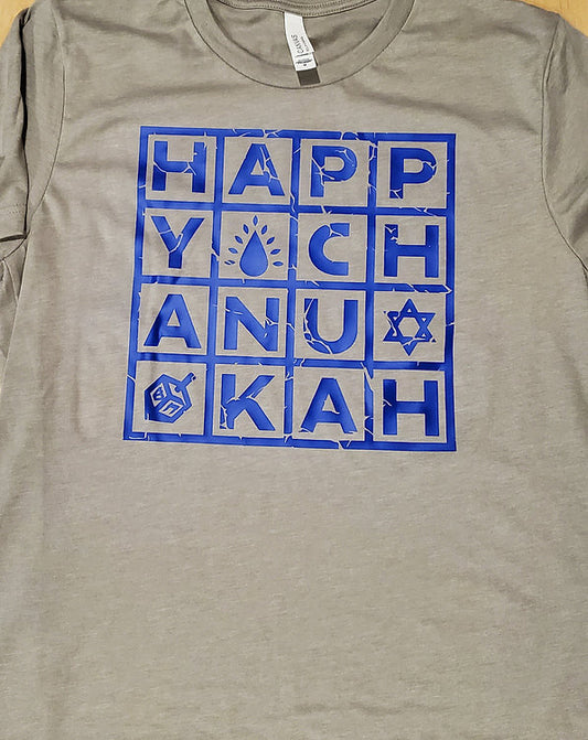 Light gray tshirt with Happy Chanukah spelled out with each letter inside a square