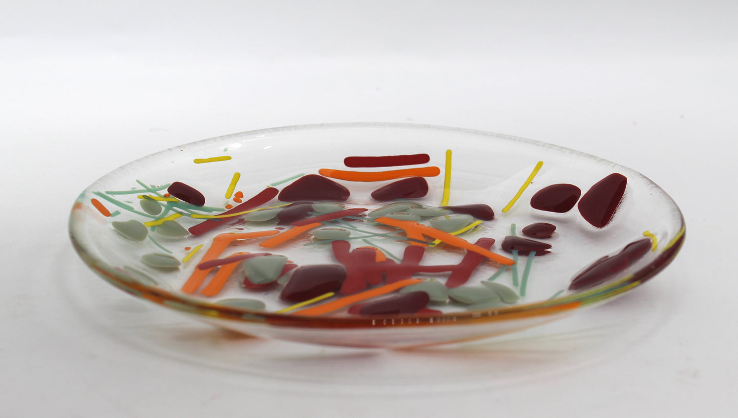 Clear Glass Bowl with lines of yellow, orange, and green & splotches of gray and dark red scattered