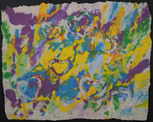 Pigmented paper artwork depicting white background with purple, yellow, green and blue color swatches with stamped hearts overlaid