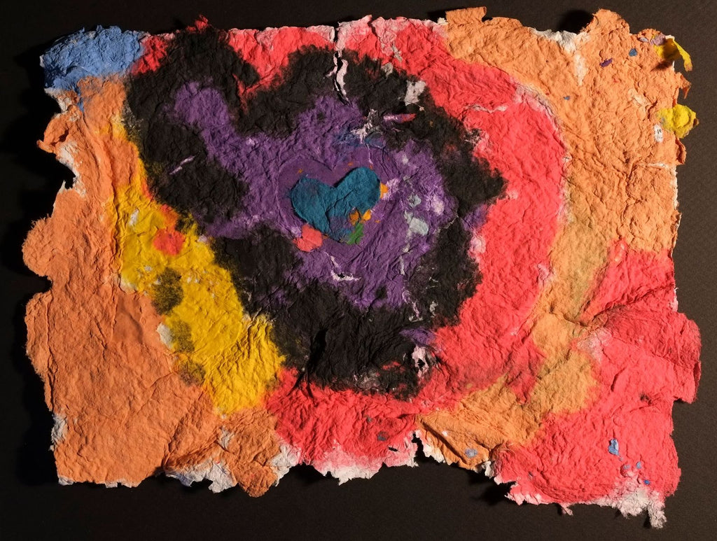 Pigment on recycled paper artwork with orange, red and yellow background with black, purple and teal hearts overlaid