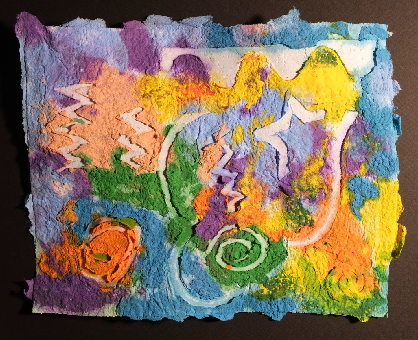 Pigment on recycled paper artwork with yellow, blue, purple, orange and green melted colors in the background with white shapes and swirls