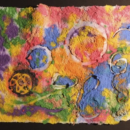Pigment on recycled paper artwork with melted colors of green, purple, yellow, red, and blue beneath white circles and squiggles