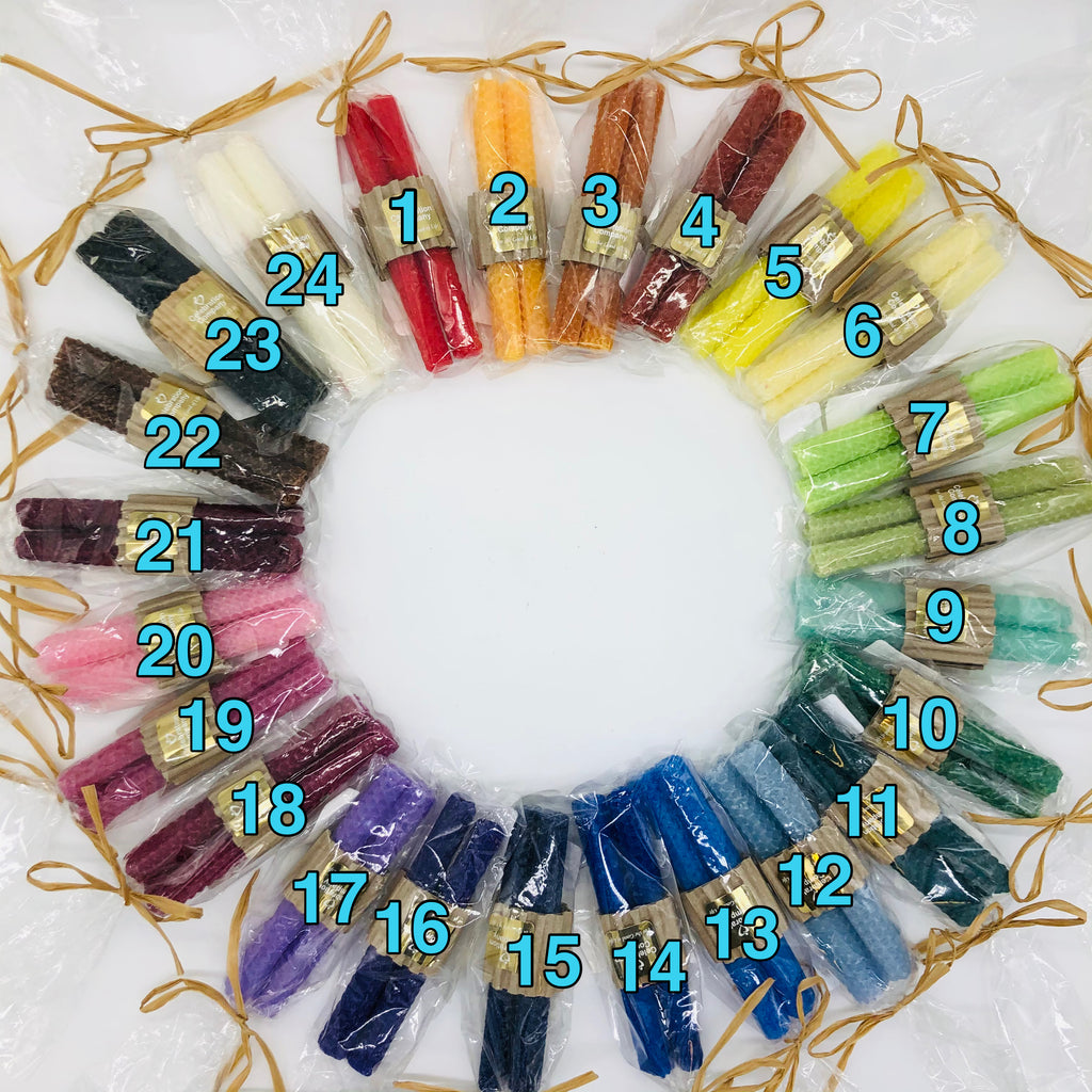 A circle of available Shabbat candle colorsavailable by number. 1 is bright red, 2 soft orange, 3 a pumpkin orange, 4 a dark terra cotta, 5 bright yellow, 6 very soft, creamy yellow, 7 bright lime green, 8 soft sage green, 9 light aqua green, 10 medium green, 11 dark green, 12 soft light blue, 13 medium blue, 14 cobalt blue, 15 very dark navy blue, 16 royal purple, 17 light purple, 18 medium maroon, 19 mauve, 20 light pink, 21 dark maroon, 22 dark brown, 23 black, 24 creamy white